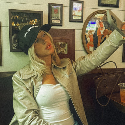 Woman in the black Afterhours Blackout hat taking a selfie