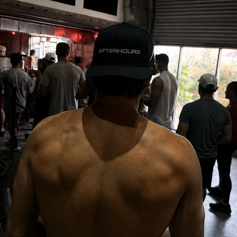 Back view of a man in the Afterhours Blackout hat at the gym